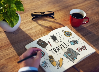 holiday travel checklist on a desk, with pen and sticky notes, ready for parents planning time-sharing.